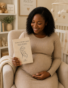 Pregnant woman reading a book in a nursery setting